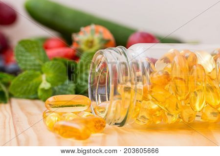 Fish oil omega 3 with vitamin D capsules good for heart health on a white backguound healthy diet concept