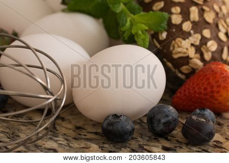 Eggs bread and ingredients prepare for cooking on marble table.