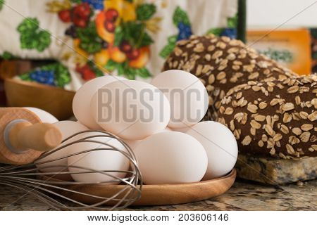 Eggs bread and ingredients prepare for cooking on marble table.