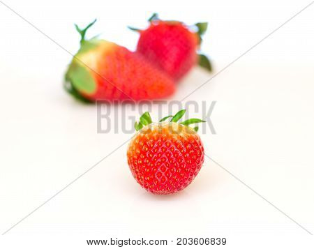 Close up of red strawberries on white background.
