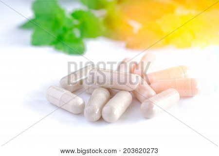 Vitamins Supplements Or Herbal In Bottle On White Table.