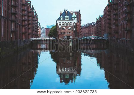 The famous Hamburg Wasserschloss water castle with the Wandrahmsfleet bridge in the Speicherstadt in Germany.
