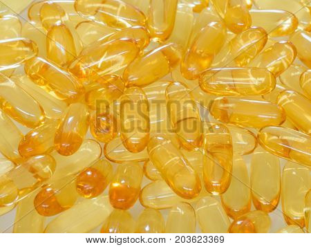 Fish oil omega 3 with vitamin D capsules good for heart health on a white backguound healthy diet concept
