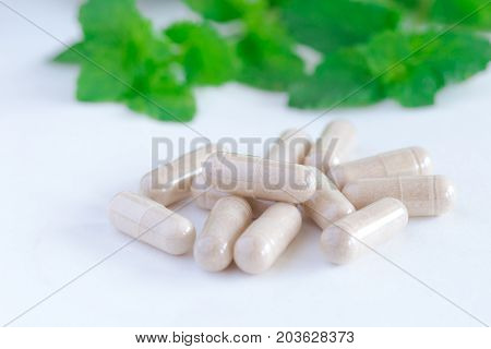 Vitamins supplements or herbal in bottle on white table.