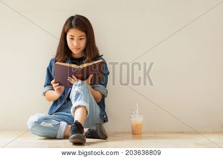 Asian Woman Reading A Book Vintage Style.