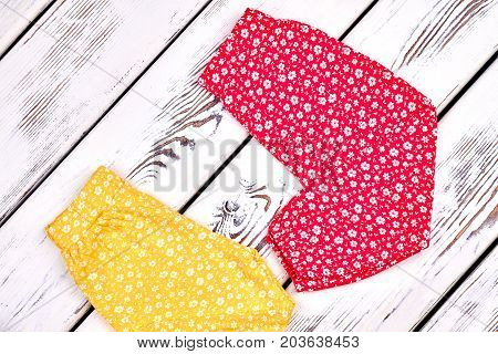 Baby girl lovely harem pants. Toddler girl cute harems on old wooden background. Infant girl summer pants on sale.