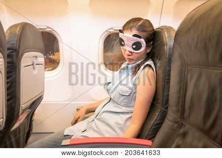Asian woman traveller sleeping in the airplane