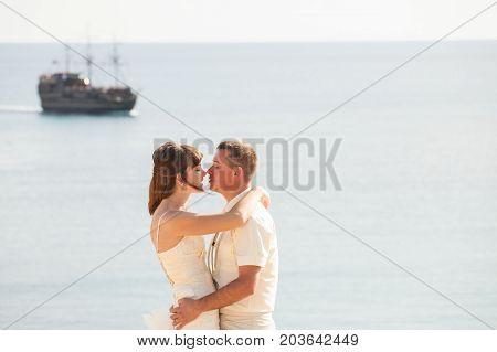 Cheerful married couple standing on the beach.