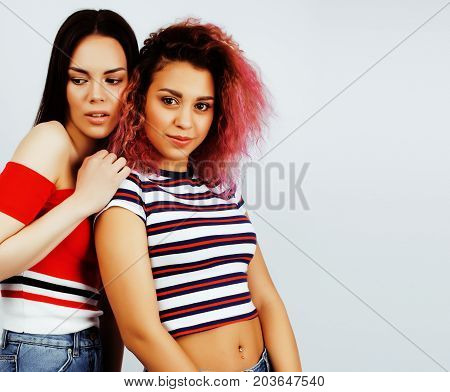 best friends teenage girls together having fun, posing emotional on white background, besties happy smiling, lifestyle people concept, blond and brunette multi nations close up