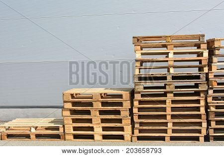 Pallets next to a warehouse building wall