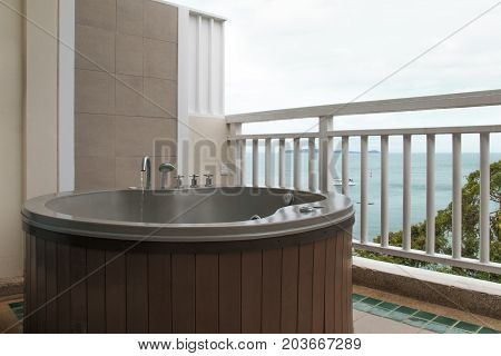 Wooden bathtub at the terrace. View nature from the terrace.