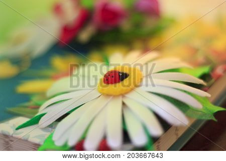 Beautiful chamomile made of white satin ribbons