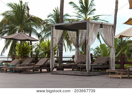 Wooden beach chairs at outdoor. Place for relaxation time.