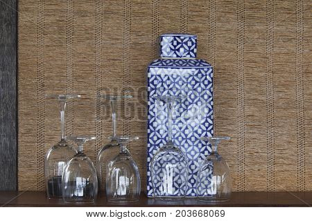 Decorate of wine glass and porcelain on wicker background.