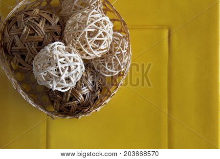 Rattan ball on yellow ceramic for decoration.