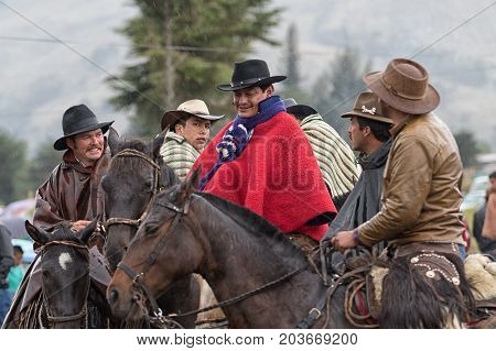 June 10 2017 Toacazo Ecuador: cowboys on horseback in the rain at high altitude in the Andes