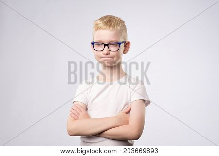Caucasian teenager with blond hair and glasses thinking isolated on white for copy space