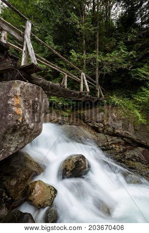 Wooden Bridge across a a running river. Taken while traveling to Widgeon Lake British Columbia Canada.
