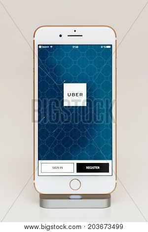 PARIS FRANCE - SEP 26 2016: New Apple iPhone 7 Plus in docking station after unboxing and testing by installing and running the app application software Uber private driving appl login register