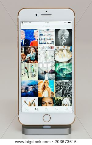 PARIS FRANCE - SEP 26 2016: New Apple iPhone 7 Plus in docking station after unboxing and testing by installing and running the app application software Instagram feed with photos and Trump and Clinton photos