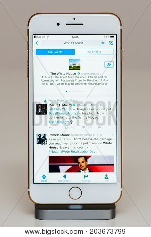 PARIS FRANCE - SEP 26 2016: New Apple iPhone 7 Plus in docking station after unboxing and testing by installing and running the app application software The White House Twitter account
