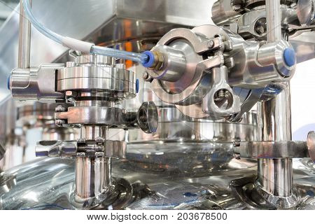 Pharmaceutical equipment, a lot of metal nipples and flanges. Abstract industrial background.