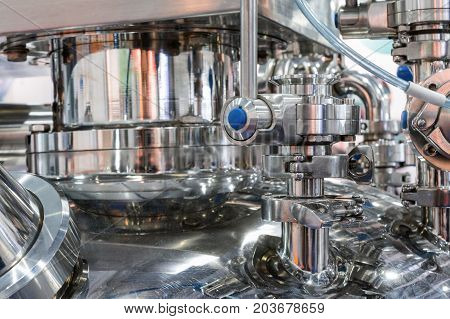 Pharmaceutical equipment, a lot of metal nipples and flanges. Abstract industrial background.