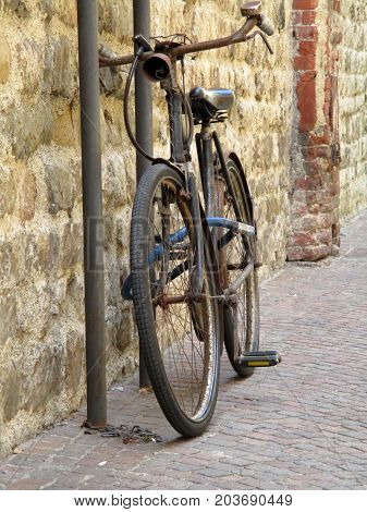 old bicycle tied on a pole b
