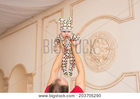 Adorable Caucasian baby and his father. Portrait of a three months old baby boy.