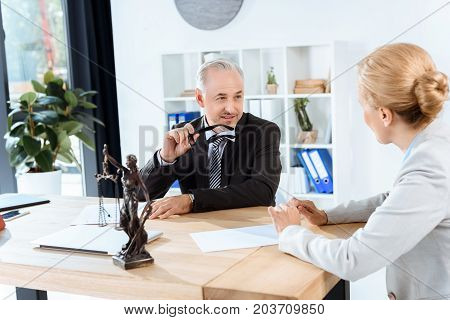 mature business colleagues discussing documents in office