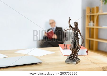 Lawyer Workplace With Themis Statue