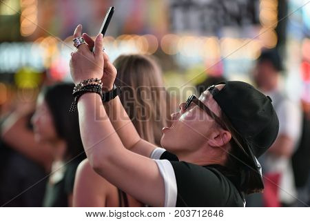 NEW YORK CITY - AUG. 26 : Unidentified people on the Times Square in Manhattan on August 26 2017 in New York City NY. Times Square is a major tourist destination and entertainment center.