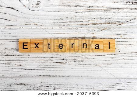 EXTERNAL word made with wooden blocks concept