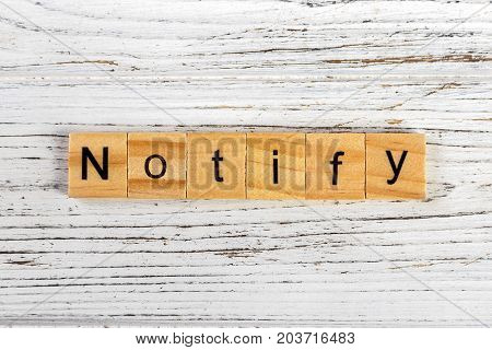 NOTIFY word made with wooden blocks concept