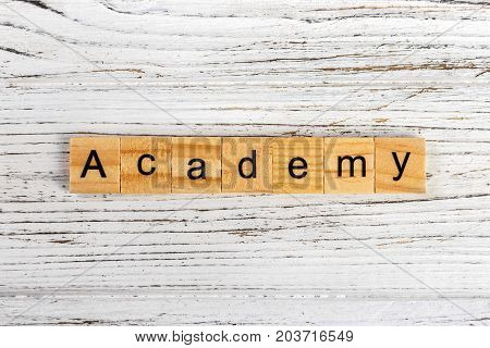 ACADEMY word made with wooden blocks concept