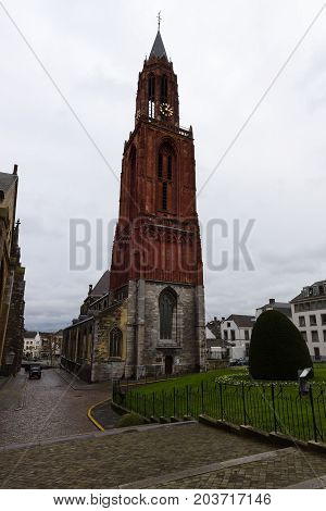 MAASTRICHT NETHERLANDS - JANUARY 09 2015: Vrijthof square. Belfry of the Evangelical Church of John the Baptist. Maastricht is the oldest city of the Netherlands and the capital city of the province of Limburg.