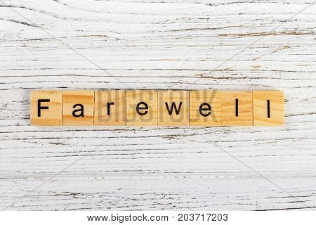 FAREWELL word made with wooden blocks concept