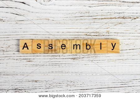 ASSEMBLY word made with wooden blocks concept