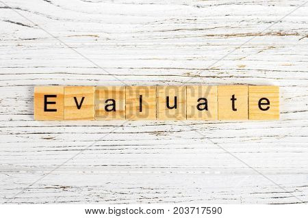 EVALUATE word made with wooden blocks concept