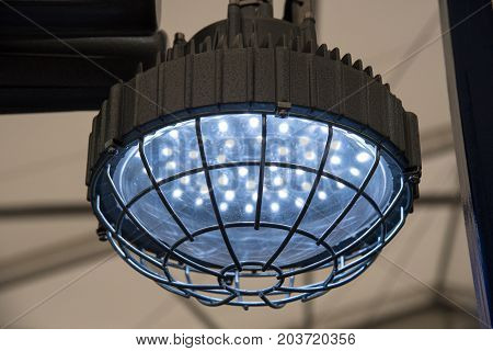 Industrial explosion-proof lantern of black and gray shines with white light at coal mining exhibition