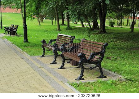 Stylish brown benches in a row in the old park