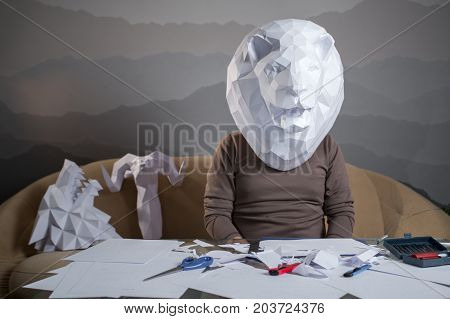 A Man With A Paper Lion's Head On The Couch