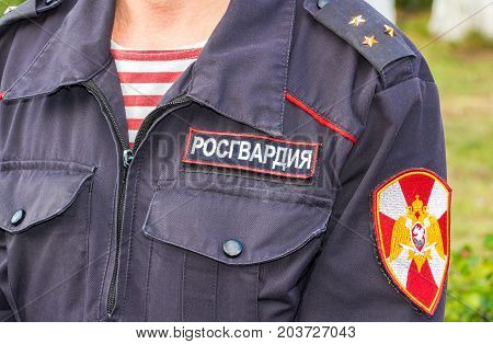 Samara Russia - September 10 2017: Russian police officer in uniform of National Guard of the Russian Federation (Rosgvardia). Rosgvardia is the internal military force of the government of Russia. Text in russian: 