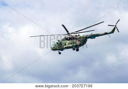 Samara Russia - September 10 2017: Russian Air Force Mi-8 helicopter in camouflage flying against cloudy sky