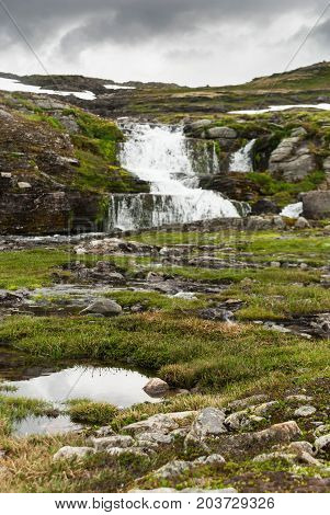 Waterfall in the mountains along the National tourist route Aurlandstjellet. Flotane. Western Norway