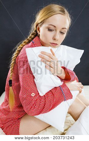 Sad Depressed Girl In Bed Gripping Pillow