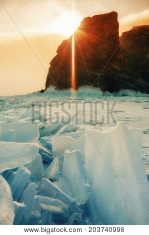 Field of blue ice and rocks Hoboy with sun. Russia. Lake Baikal