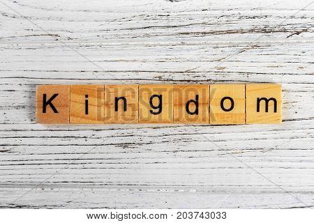 KINGDOM word made with wooden blocks concept