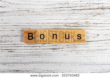 BONUS word made with wooden blocks concept