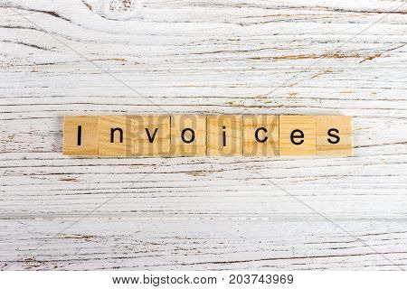 INVOICES word made with wooden blocks concept